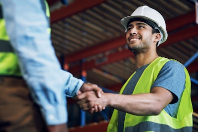 Construction worker shaking hands