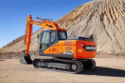 Develon DX140LC-7 excavator beside huge dirt pile