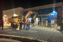 komatsu excavator parked outside Fla. walmart after running into automotive department wall