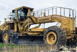 Garret Wilson beside huge Champion motor grader.