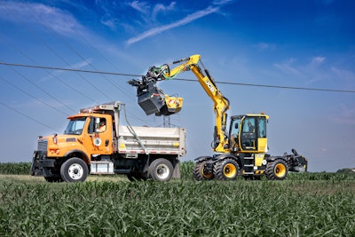 JCB pothole pro dumping road debris into dump truck bed