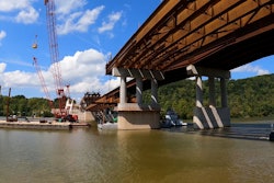 main steel span of Donald M. Legg Memorial Bridge in West Virgina being lifted into place