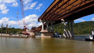 main steel span of Donald M. Legg Memorial Bridge in West Virgina being lifted into place