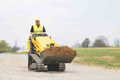 New Holland C314 mini track loader carrying bucketful dirt