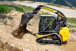 New Holland C330 compact track loader dumping dirt