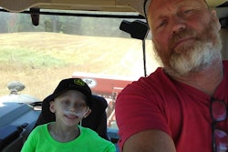 Roger Wenning with grandson Travis in tractor cab