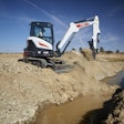 Bobcat E38 compact excavator beside ditch with water in it