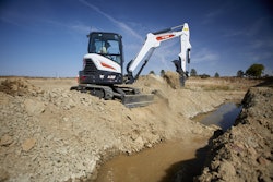Bobcat E38 compact excavator beside ditch with water in it