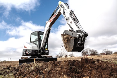 Bobcat E55 compact excavator digging trench