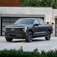 Platinum black Ford F-150 Lightning pickup truck parked on driveway