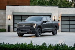 Platinum black Ford F-150 Lightning pickup truck parked on driveway