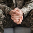 closeup of soldiers hands while seated