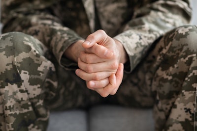 closeup of soldiers hands while seated