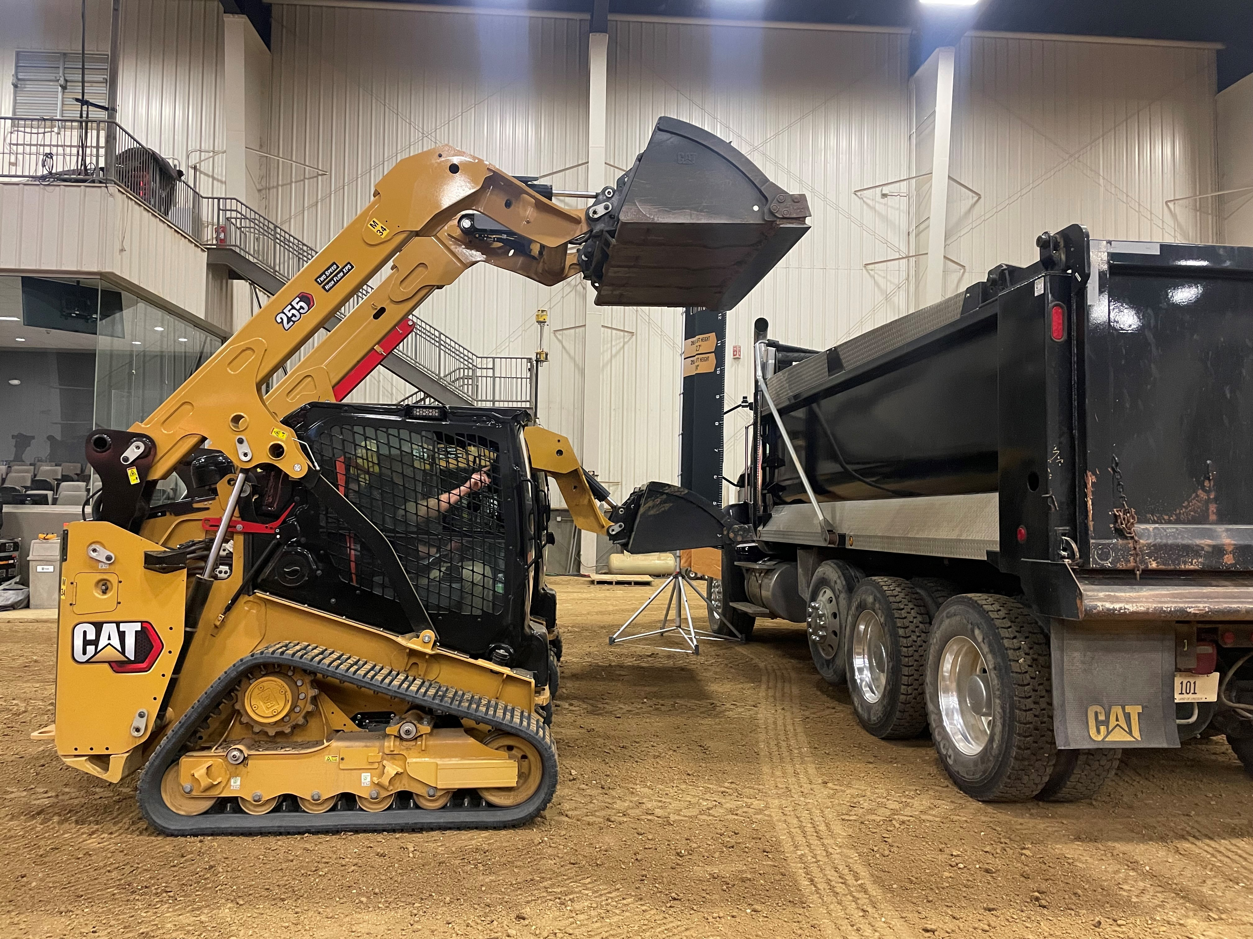 Cat 255 and 265 Compact Track Loaders loading dump truck