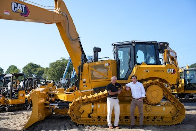 Greg Poole III and Greg Poole IV in front of Cat dozer Gregory Poole Equipment Co