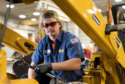 Gregory Poole Equipment technician wearing shades holding wrench