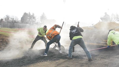 K&L Industries workers spreading hot mix asphalt