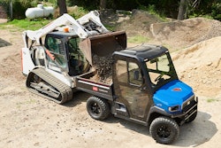 Bobcat CTL loads gravel in the bed of a Toro Workman UTX