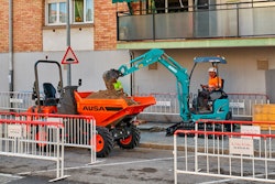 AUSA d201ahg site dumper on urban jobsite being loaded by mini excavator