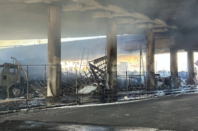 charred remains underneath I10 freeway in L.A. after storage yard fire