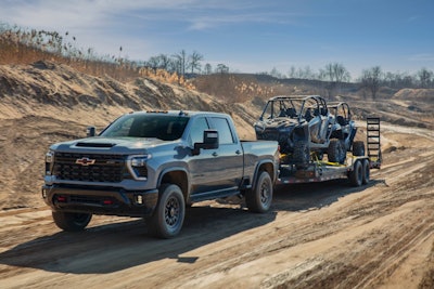 2024 chevrolet silverado hd zr2 trilering 2 ATVs on dirt road