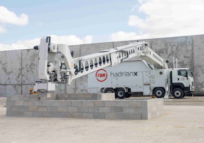 white FBR Hadrian X truck-mounted brick laying robot building masonry block wall