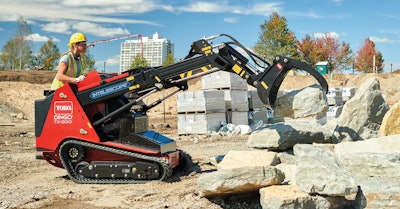 Toro TX1300 compact utility loader grabbing boulder