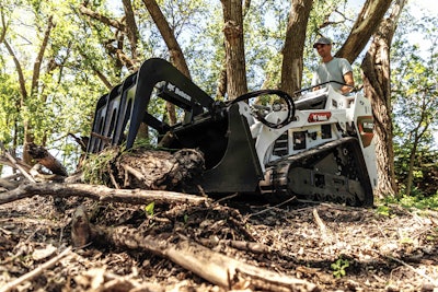 bobcat mt100 compact utility loader grabbing tree debris