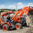 Kubota L47 Backhoe Loader dumping gravel