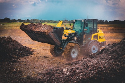 Gehl 650 compact wheel loader hauling dirt