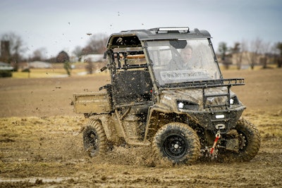 Landmaster AMP utility vehicle driving through mud