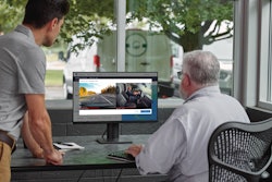 Two fleet employees at computer monitoring dashcam footage