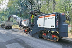 Wirtgen W220XFi cold planer dumping asphalt millings in truck bed