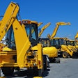line-up of backhoes at auction