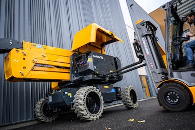 Range Extender on Haulotte HA46 E Pro boom lift. being removed by forklift