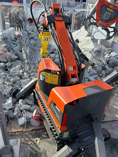 Husqvarna DXR 95 Demolition Robot in front of broken asphalt