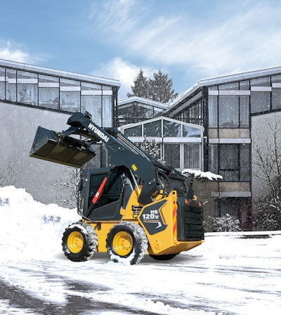 Hyundai HS120V skid steer bucket raised in snow
