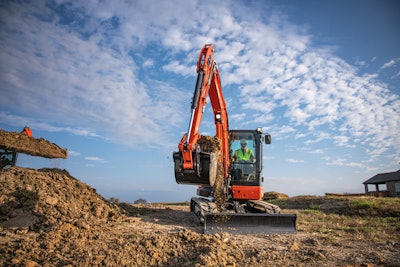 Kubota KX057-5 mini excavator with bucketful of dirt