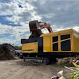 Excavator loading material into the Vermeer LS3600TX low speed shredder