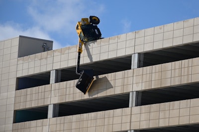 JCB telehander hangs off the side of the top of parking garage after tipping madison wisconsin