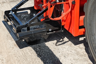 Crafco EZ Patcher Drag Box applying mastic to pavement
