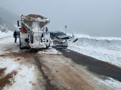 silver jeep cherokee crashed into snow bank beside snowplow