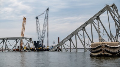 cranes stationed at collapsed baltimore bridge for salvage operations