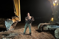 ECO Jarecki holds a bear cub rescued from an excavator cab