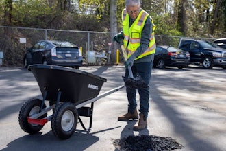 Microsoft co-founder Bill Gates fills a pothole with shovel and wheelbarrow with Modern Hydrogen asphalt