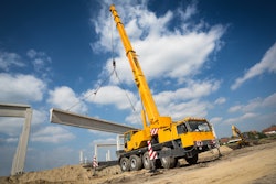 stock image mobile crane hoisting concrete beam