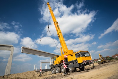 stock image mobile crane hoisting concrete beam