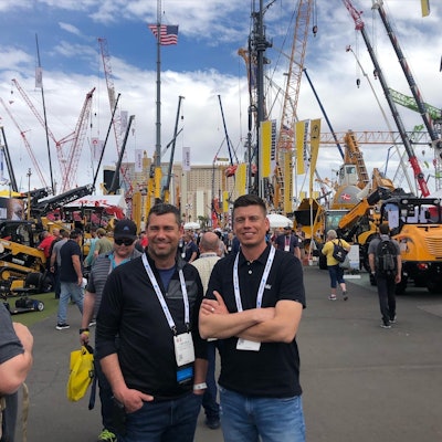 tony and brian dietz at conexpo 2023 cranes in background