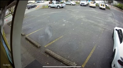 Loose saw blade barreling across a parking lot