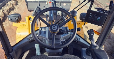 Volvo compact wheel loader interior view of steering wheel out window to bucket